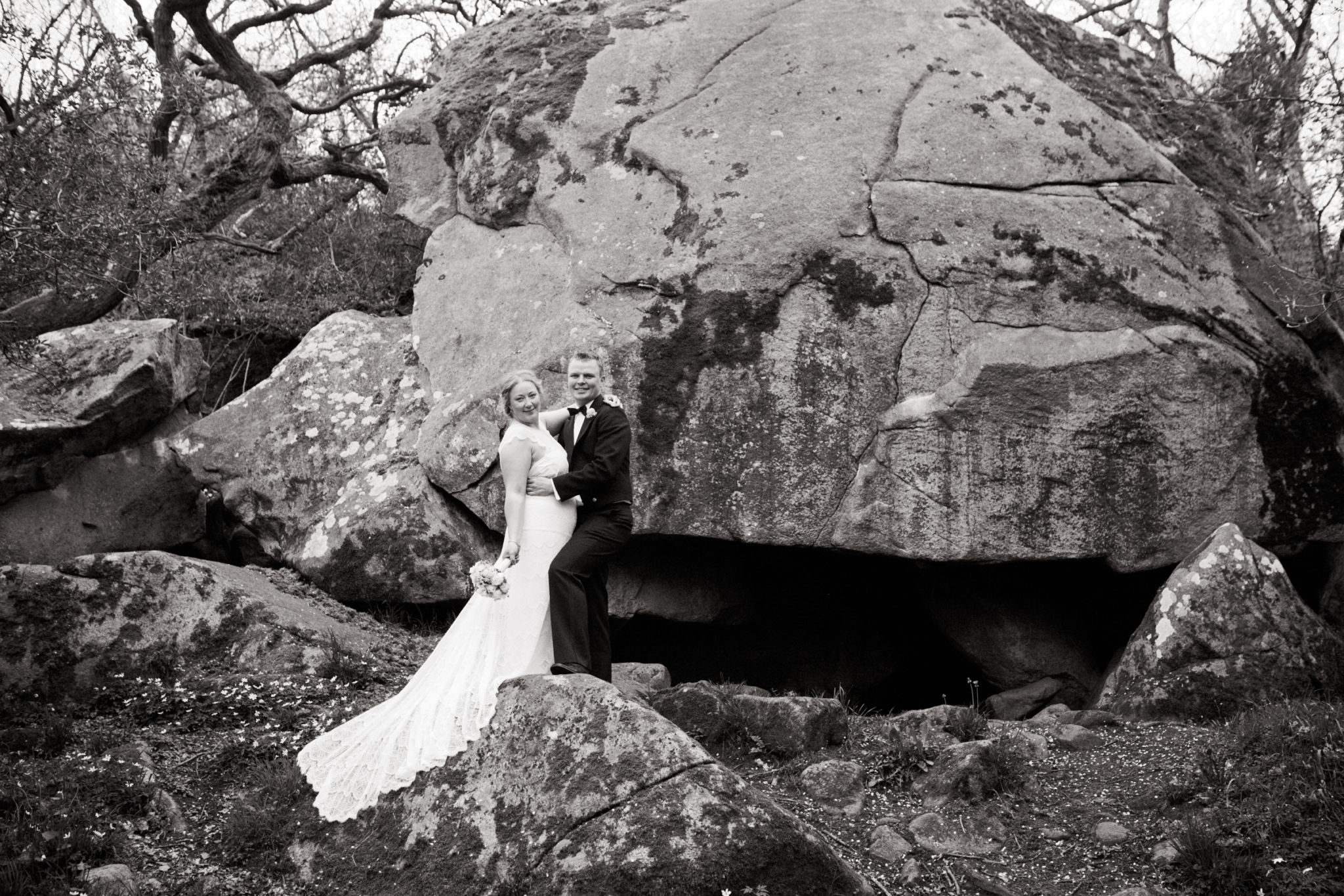 Bride and groom pose in front of cliffs on Bornholm