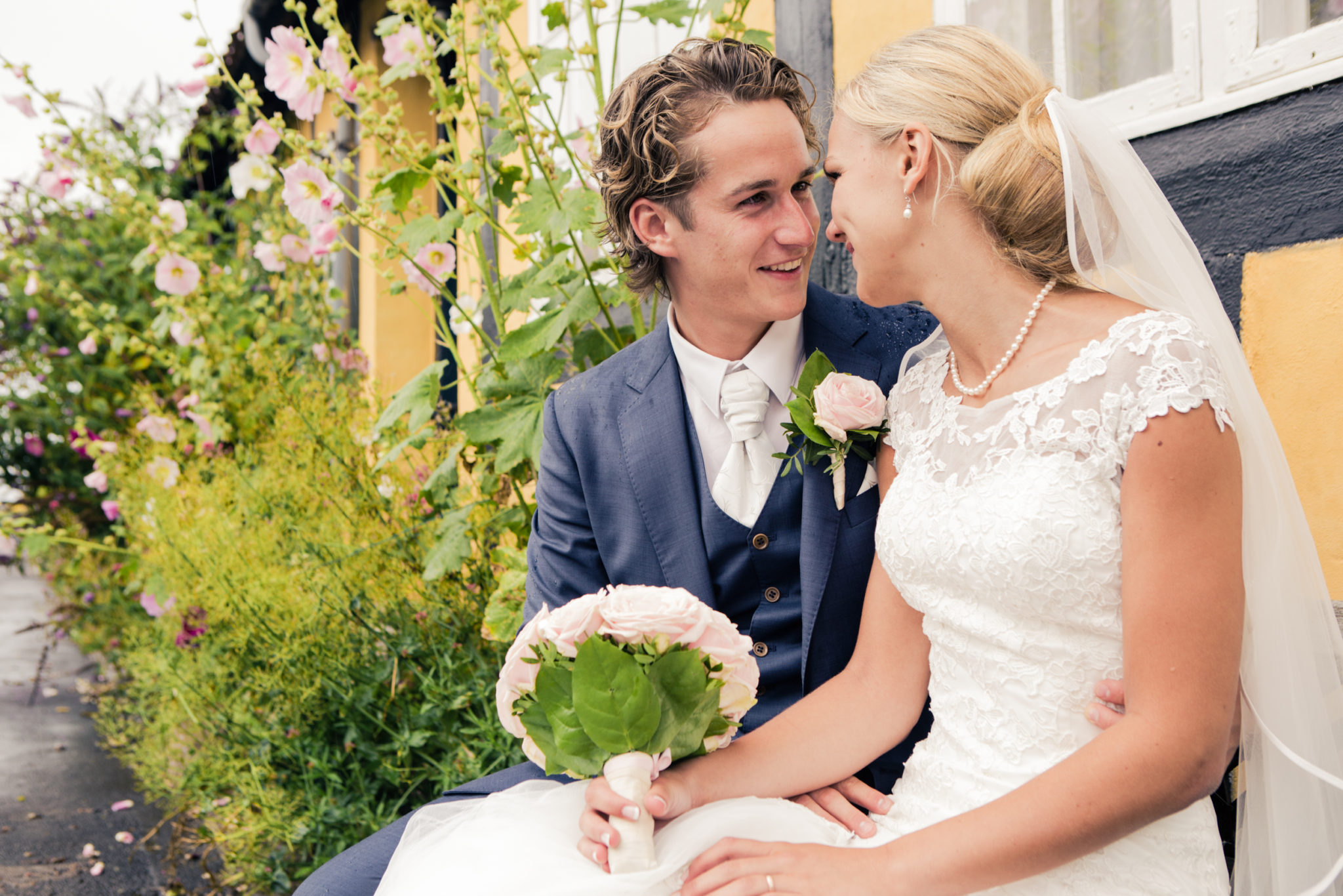 Bridal couple sitting by the town hall on Bornholm in Denmark