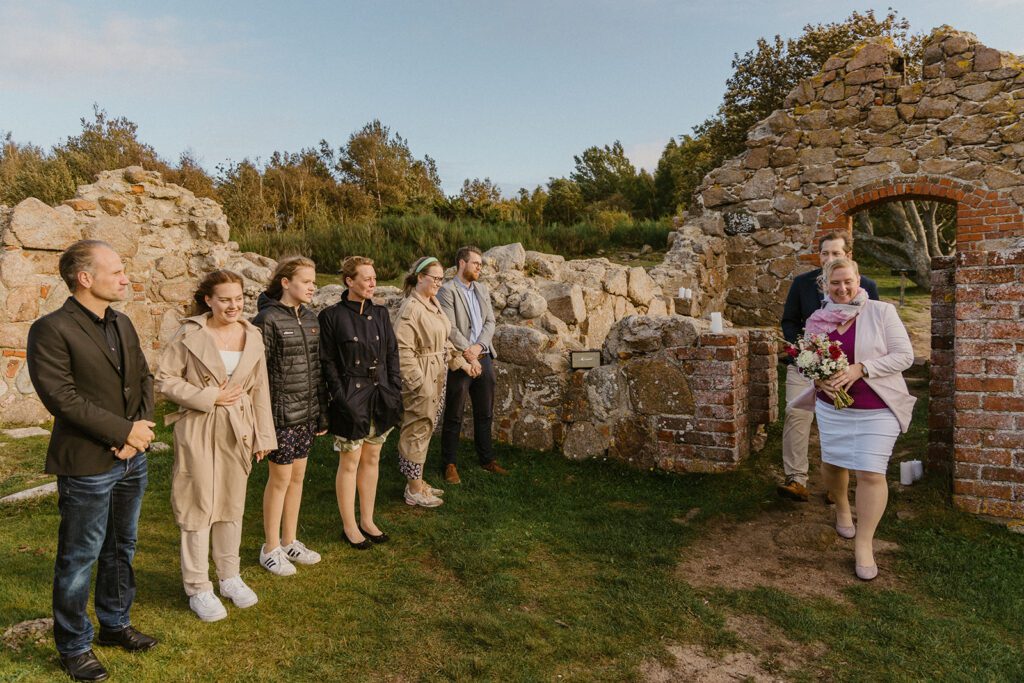 A German couple about to be married walks down a natural aisles in the ruins of Salomon's Chapel on Bornholm in Denmark.