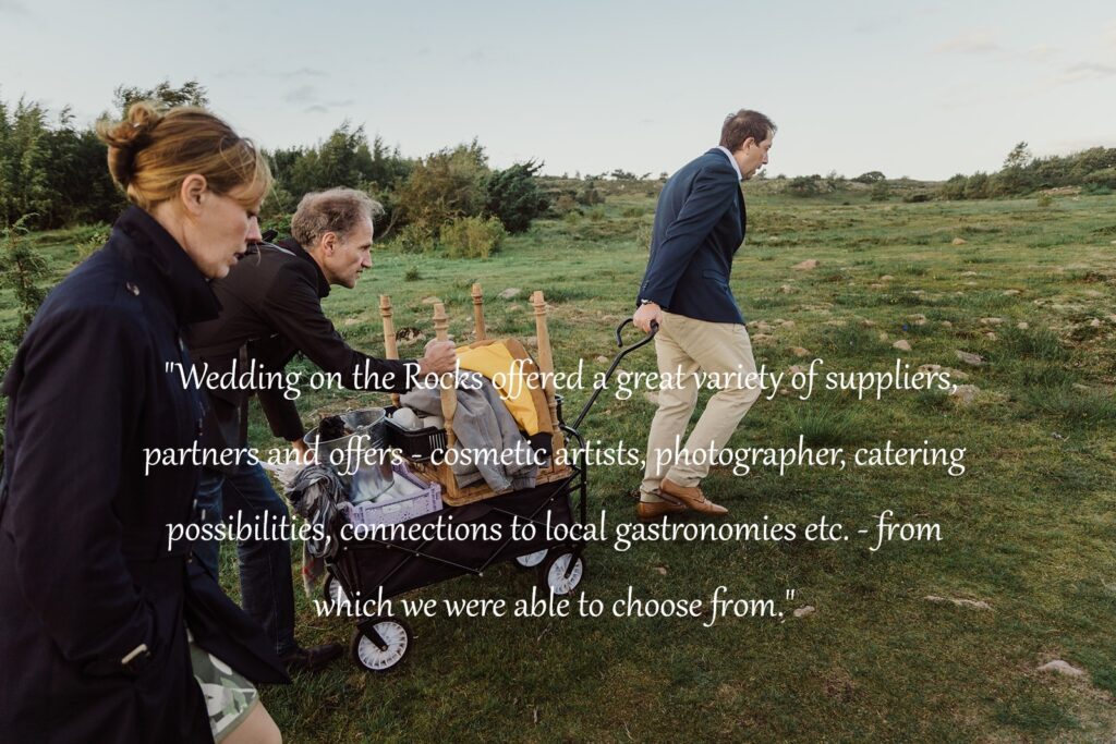 The groom and some guests pull a trolley with wedding paraphernalia up a slope on the Danish island of Bornholm.