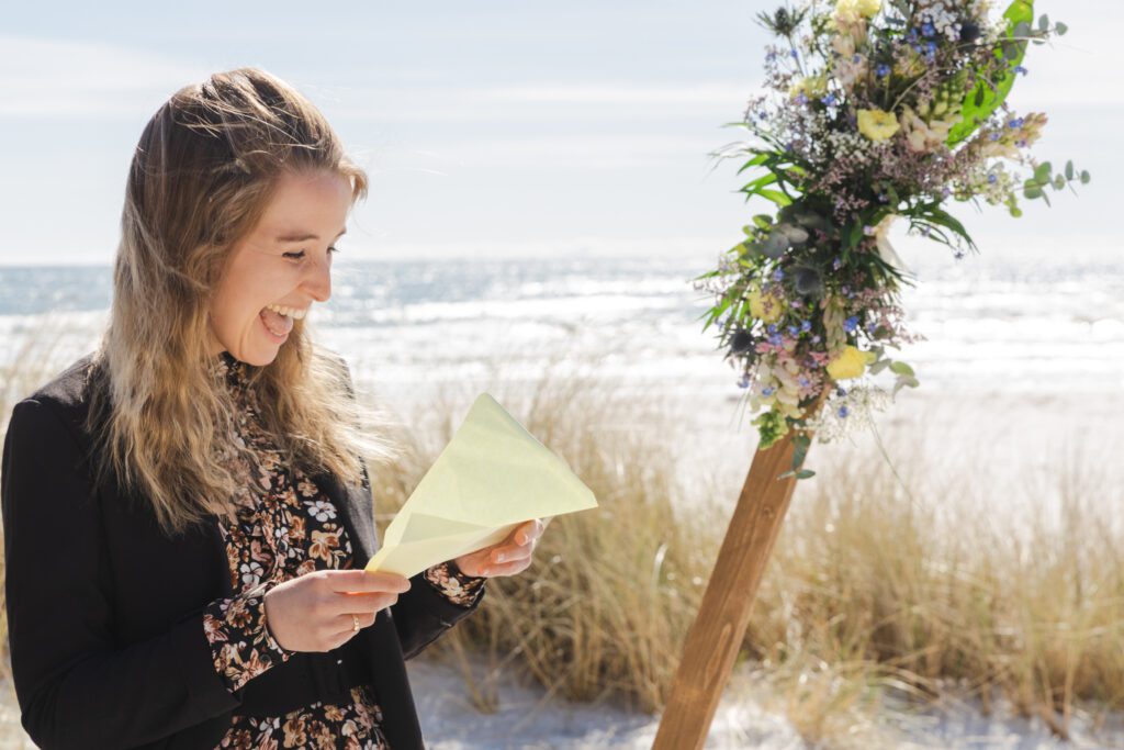 A bride laughing when looking at her wedding budget on Bornholm.