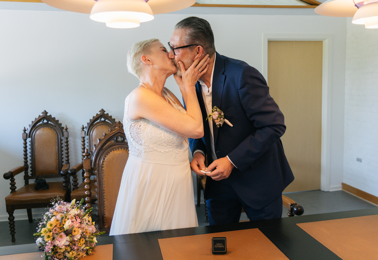 A couple kisses after the wedding ceremony in the registry office in Rønne on Bornholm.