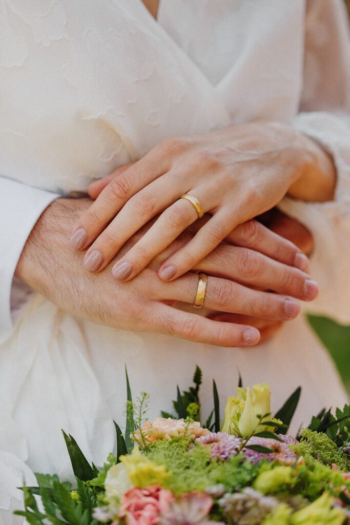 A couple shows off their wedding bands after their wedding on Bornholm in Denmark.