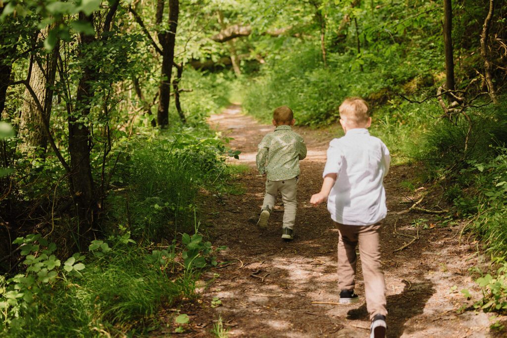 Two small German boys run through nature on Bornholm after their parents wedding at the registry office in Rønne.