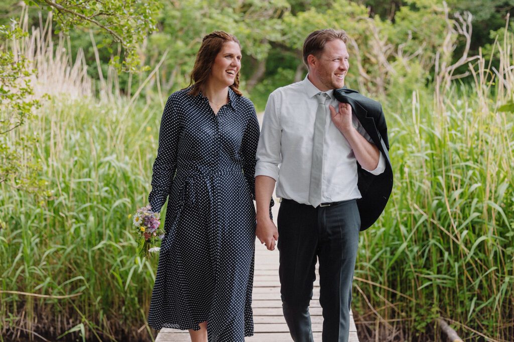 Bride and groom walk through nature on Bornholm after their wedding ceremony in the local registry office.