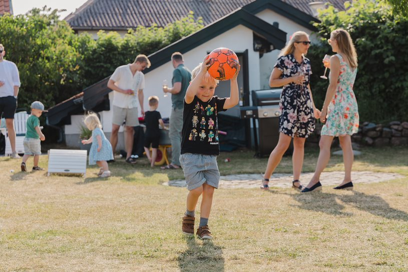 A child plays with a ball during a beach wedding on Bornholm .