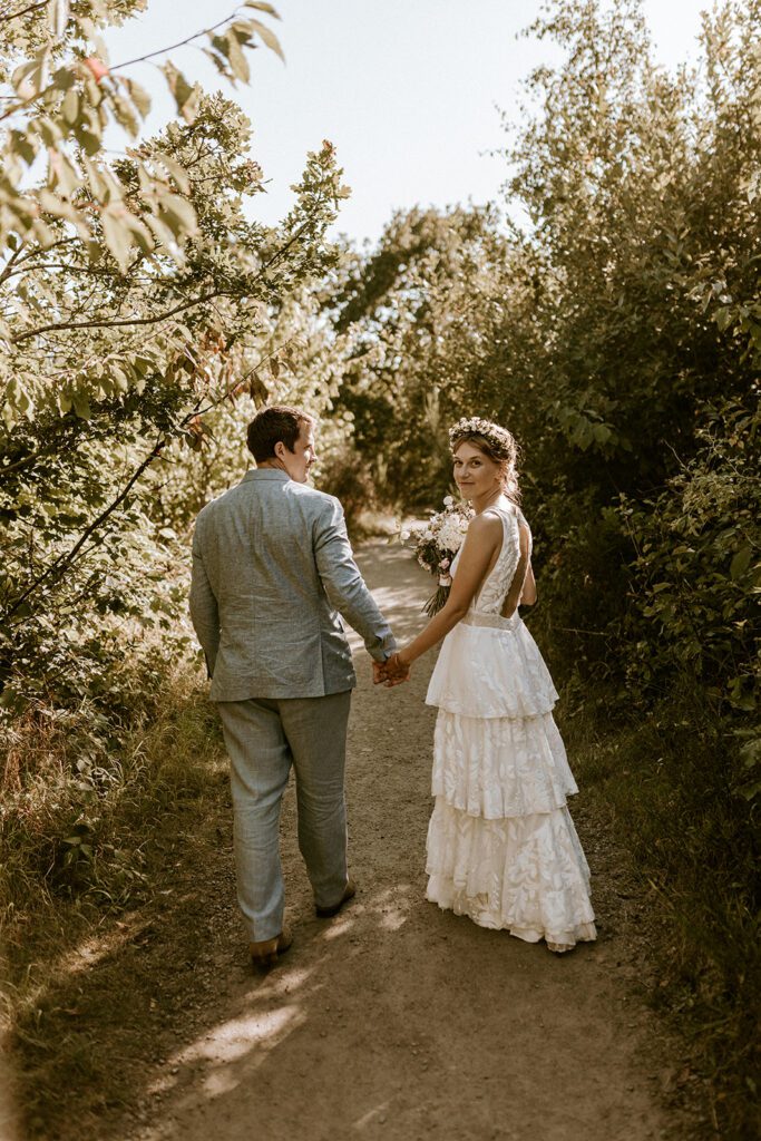 A newly wed couple walks through a Danish wood on Bornholm.