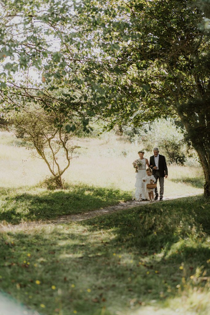 A bride, her father and a flower girl walk down the aisle in Denmark.