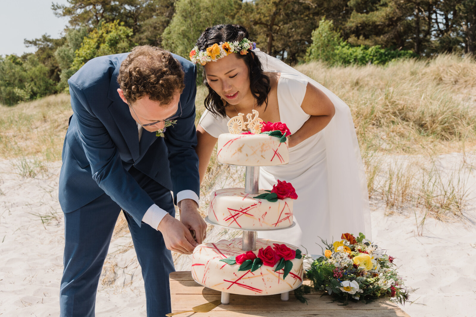 A couple cuts their wedding cake in Denmark.