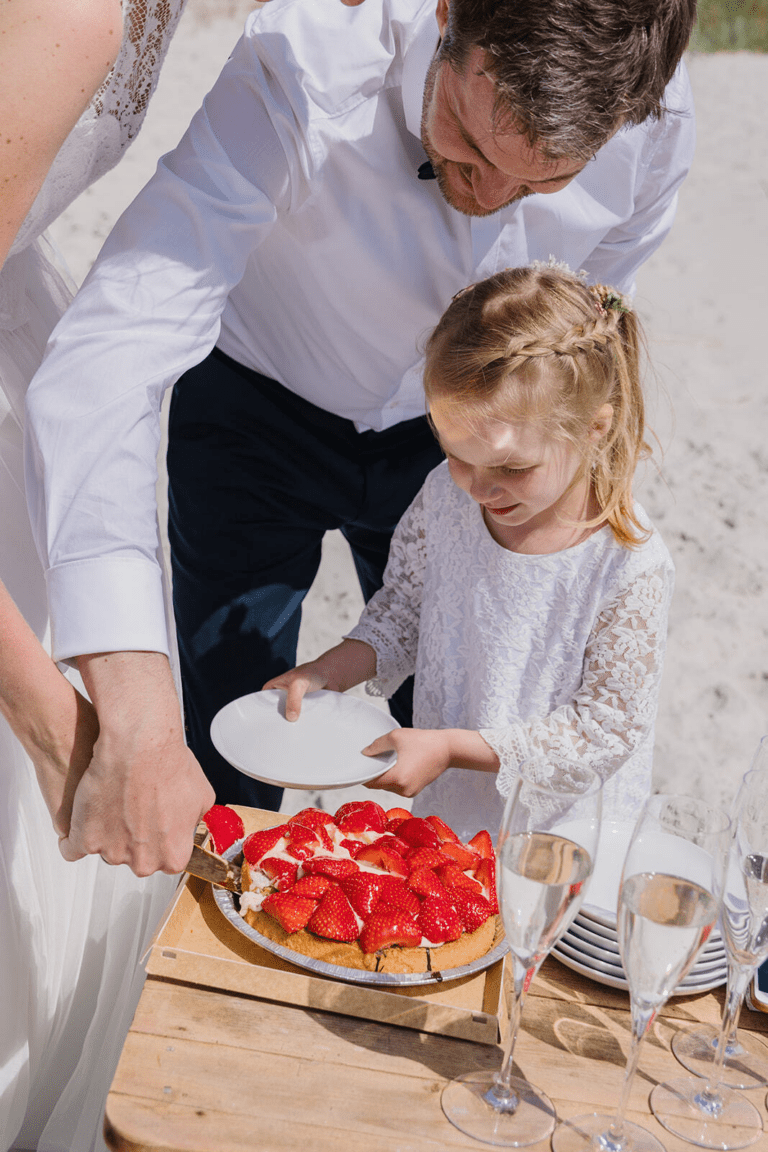 A small child eats wedding cake during a wedding in Denmark.